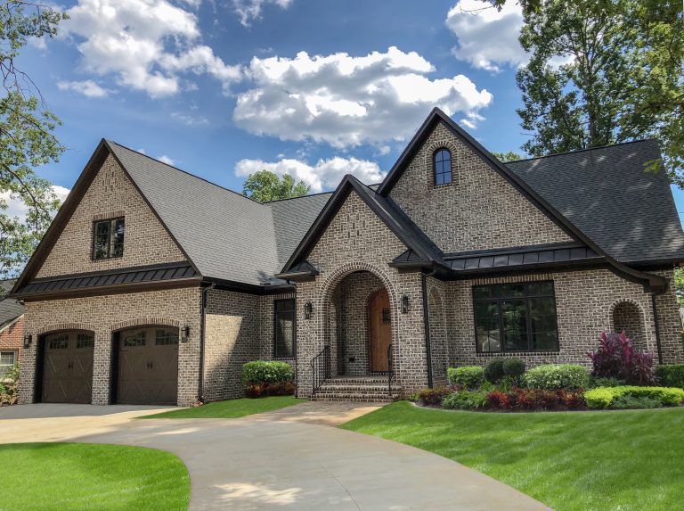 Tufts House with Ashton Court brick accents help define a modern Tudor home in an established neighborhood