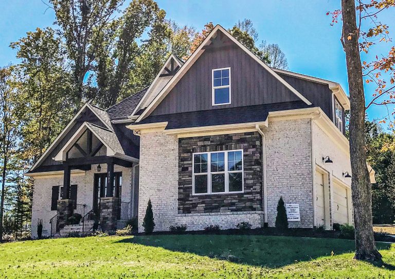 White brick, dark trim and stone set this show home apart