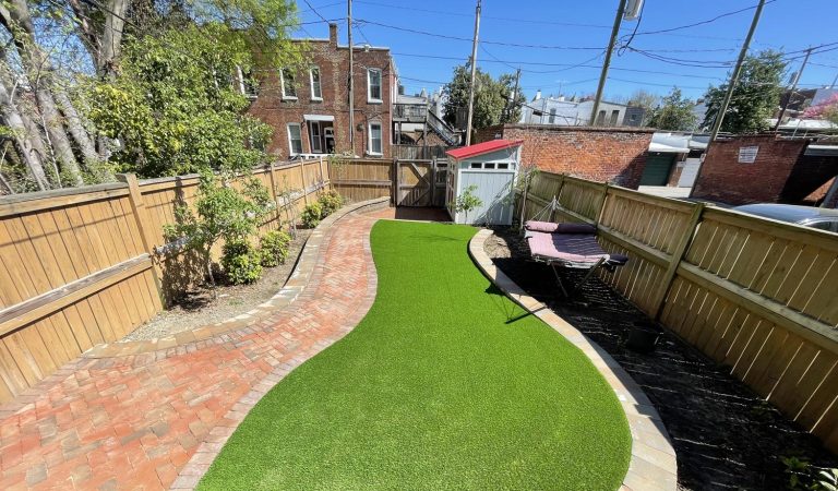 Two dogs, a baby, and a patchy lawn? Try synthetic turf and clay pavers